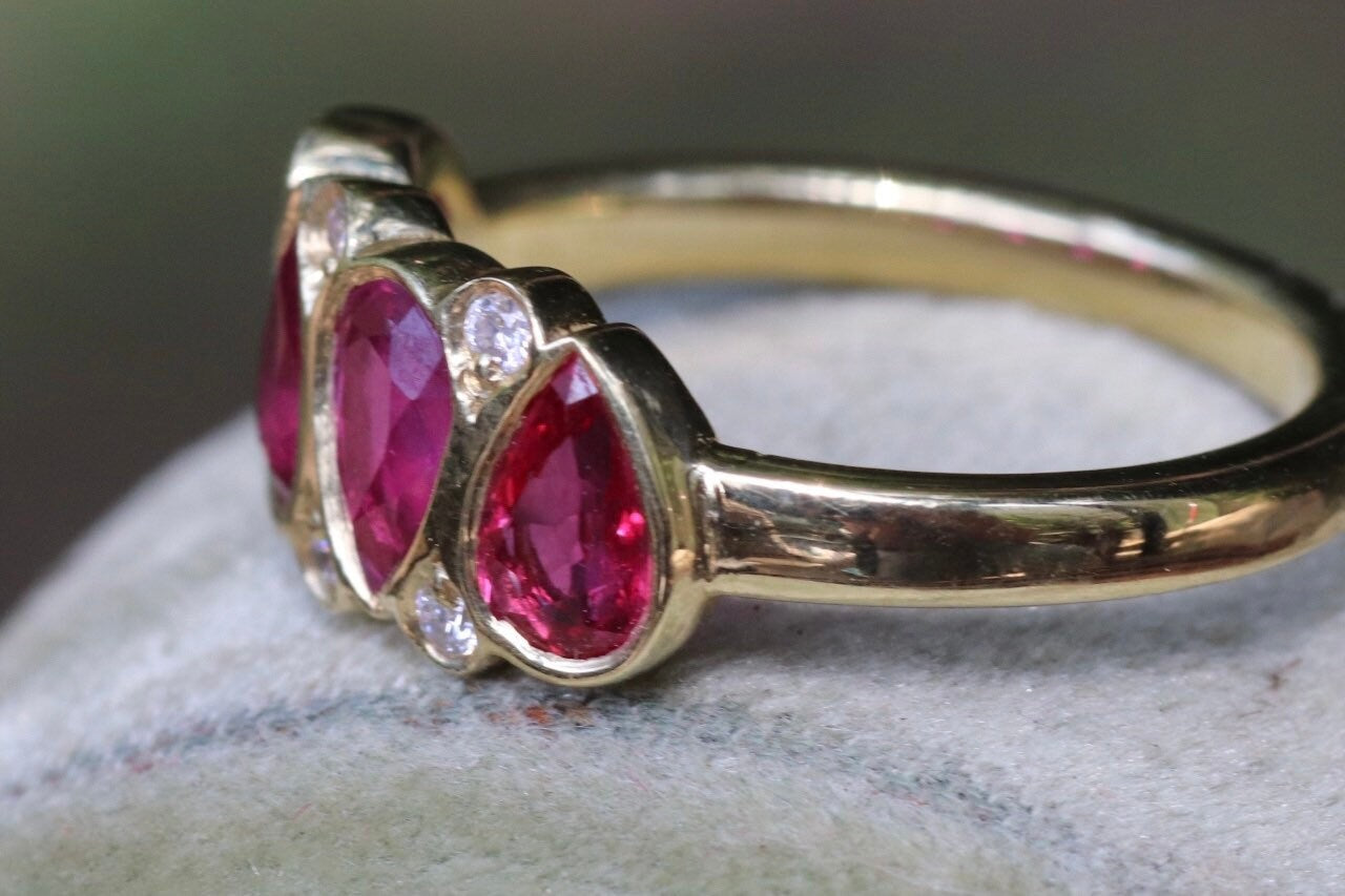 2.11 carat unheated rubies and .08 GVS diamond set an 18 K size 6.5 (sizable)