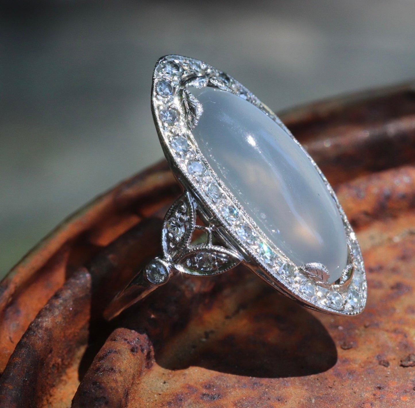 Genuine Art Deco moonstone ring with natural diamond halo set in platinum