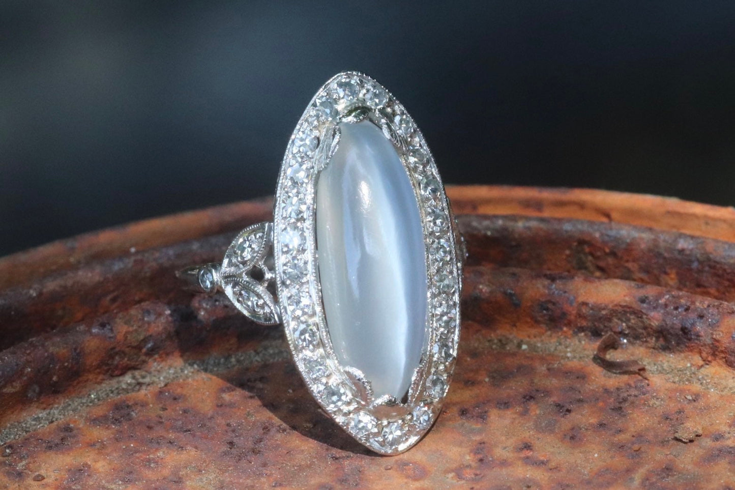 Genuine Art Deco moonstone ring with natural diamond halo set in platinum