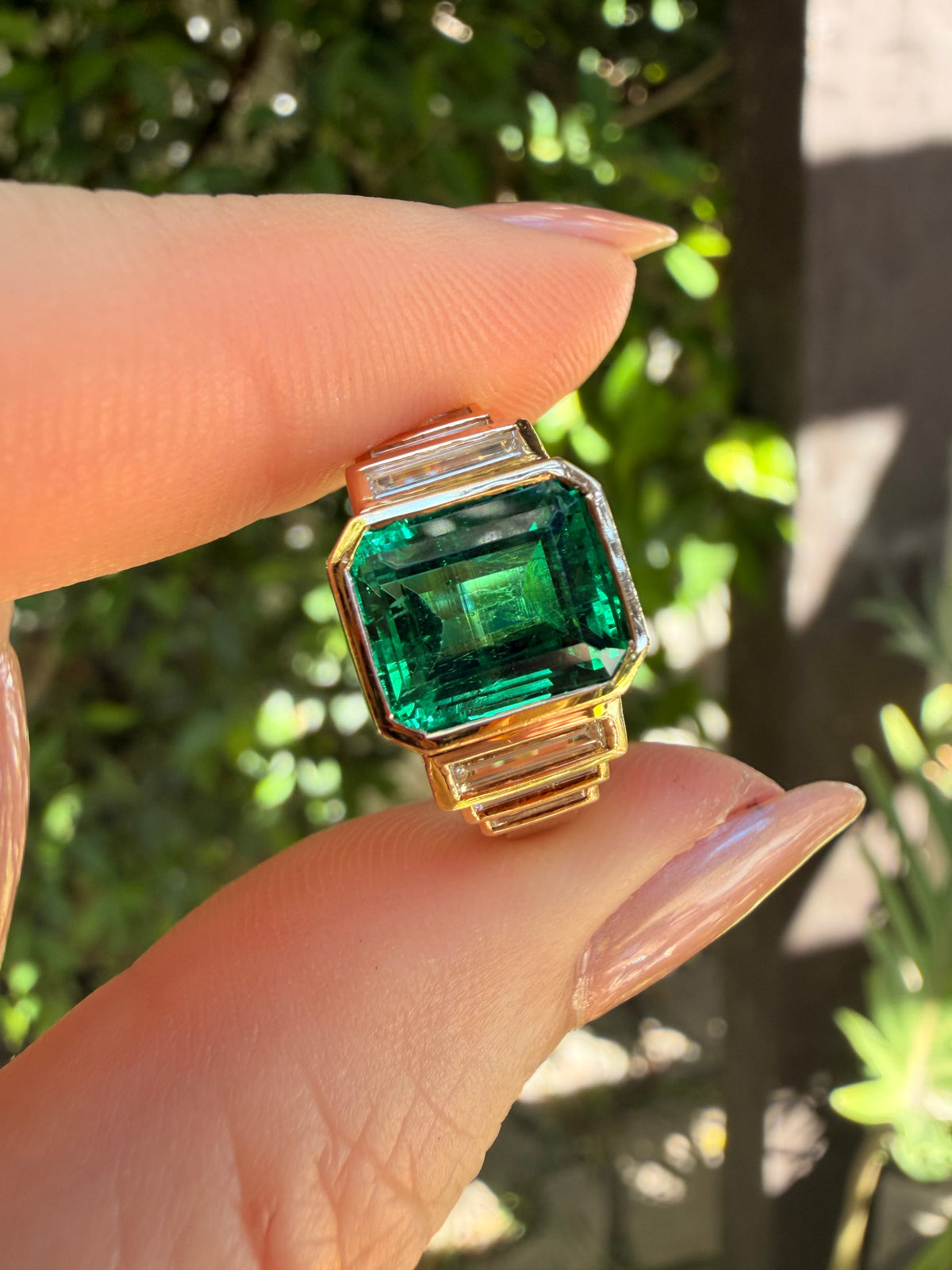 AGL certified Colombian Emerald F1 treatment ring with straight baguette diamonds in 14 karat yellow gold