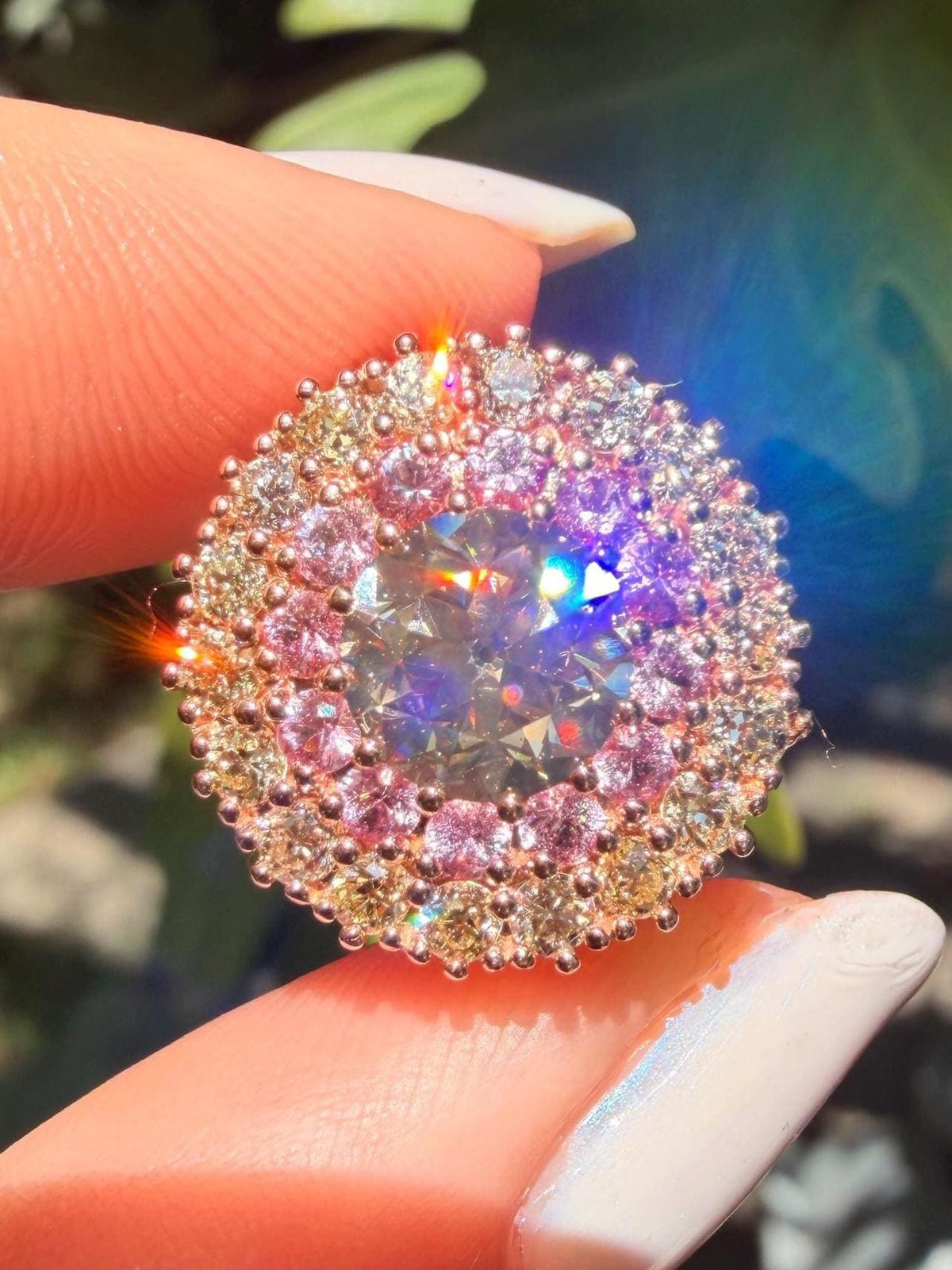Old European cut diamond ring in 14 karat rose gold with natural pink sapphires and an old European cut diamond halo