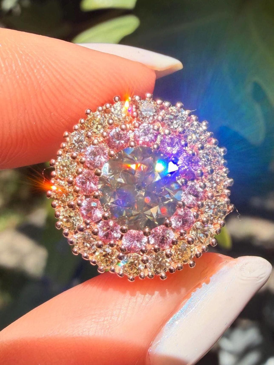 Old European cut diamond ring in 14 karat rose gold with natural pink sapphires and an old European cut diamond halo