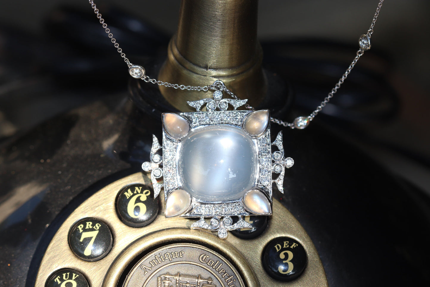 Cat’s eye moonstone and diamond pendant set in 18k gold includes a 17.5” diamonds by the yard chain in 14k gold