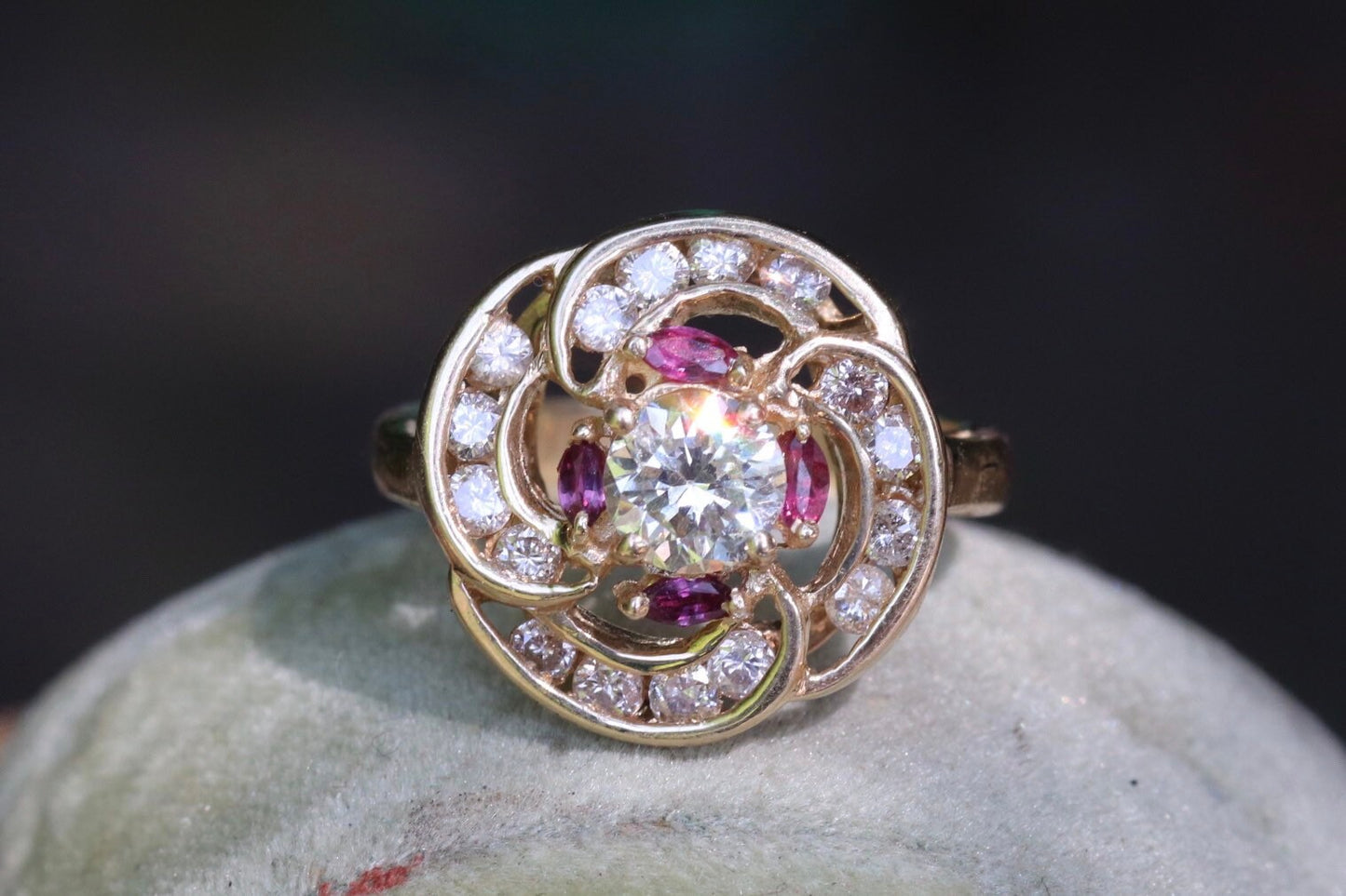 Transitional cut diamond set in 14k yellow gold surrounded by rubies and modern round diamonds size 5.75 (sizable)