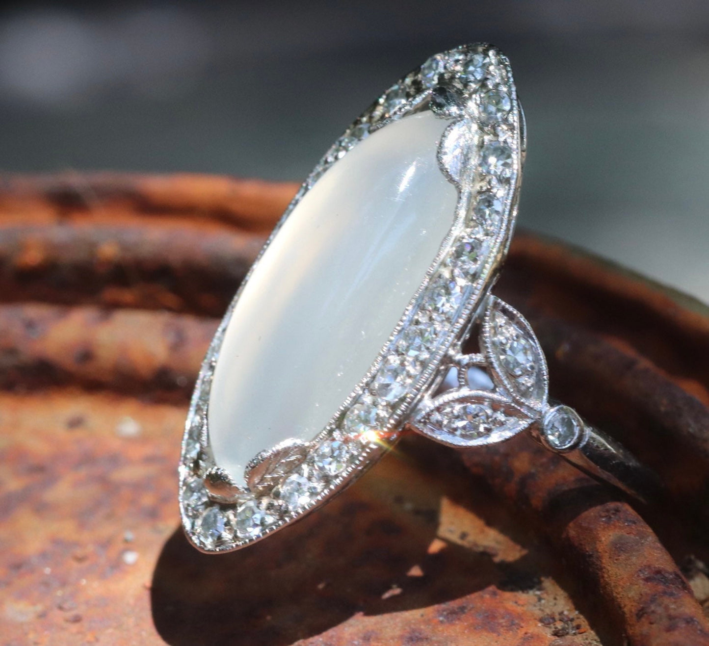 Genuine Art Deco moonstone ring with natural diamond halo set in platinum