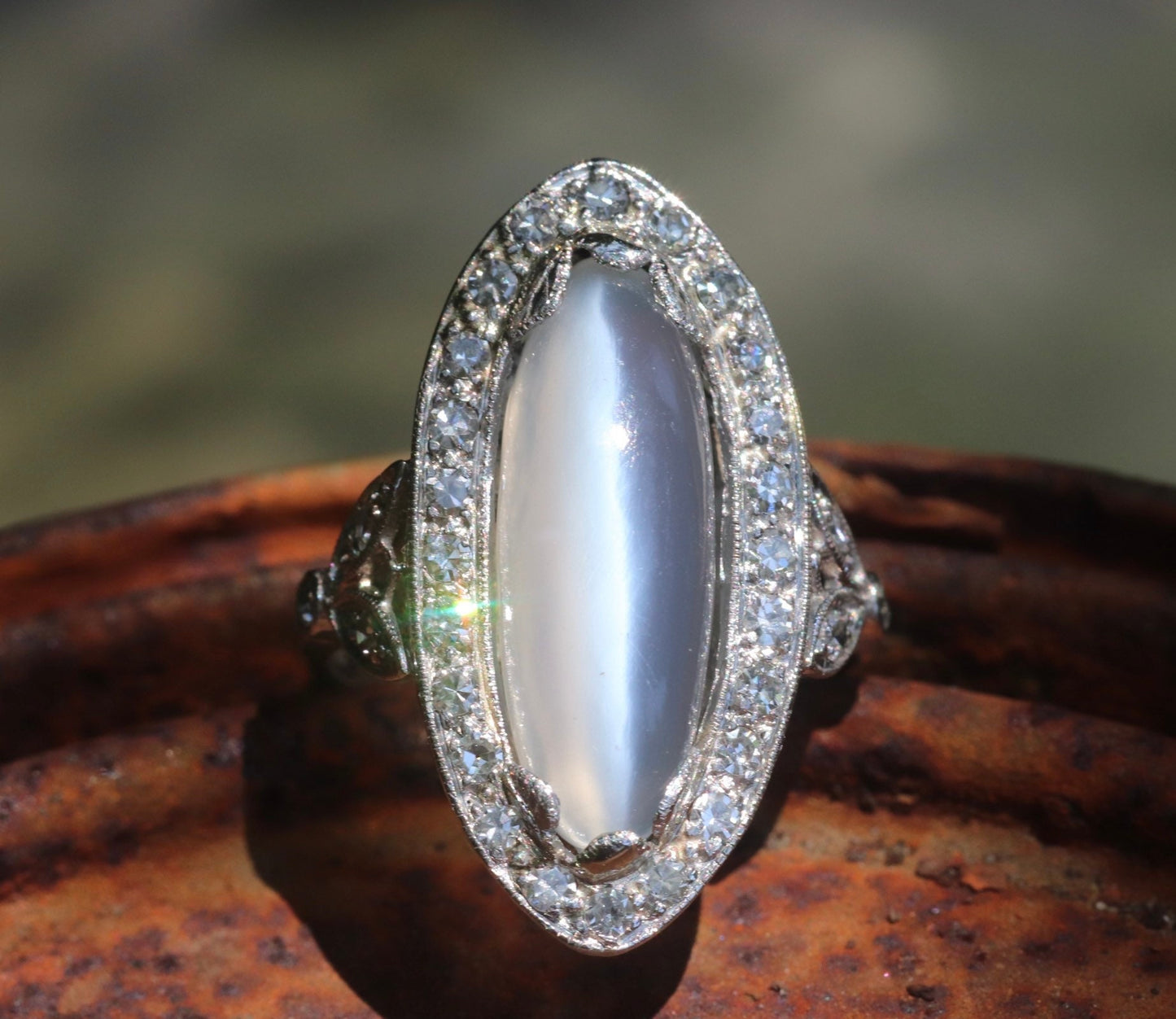Genuine Art Deco moonstone ring with natural diamond halo set in platinum